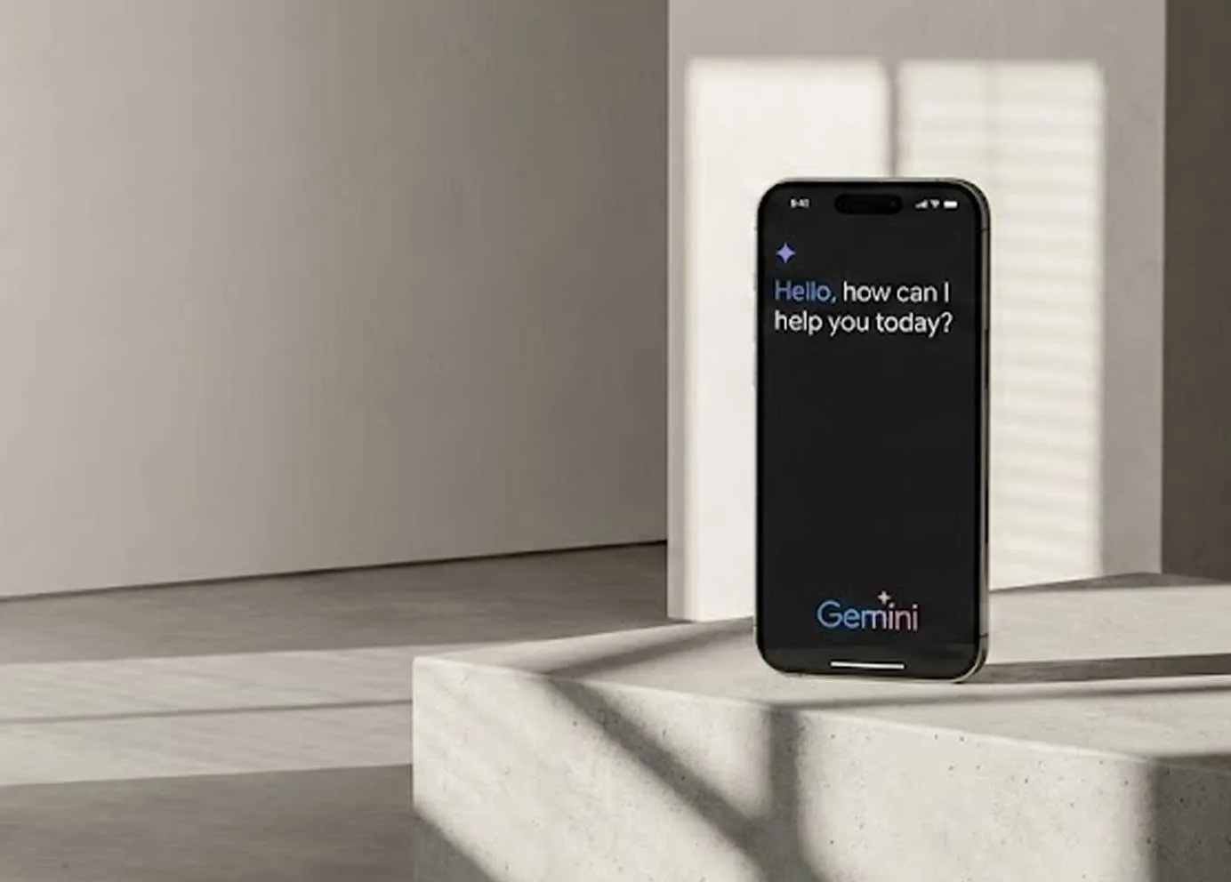 A phone showing a Gemini assistant, beside a stone plinth